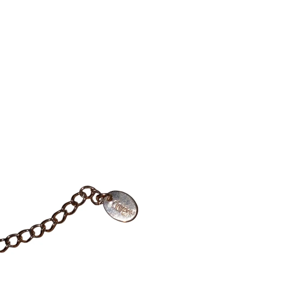 Claire's silver necklace with a green cat's eye pendant